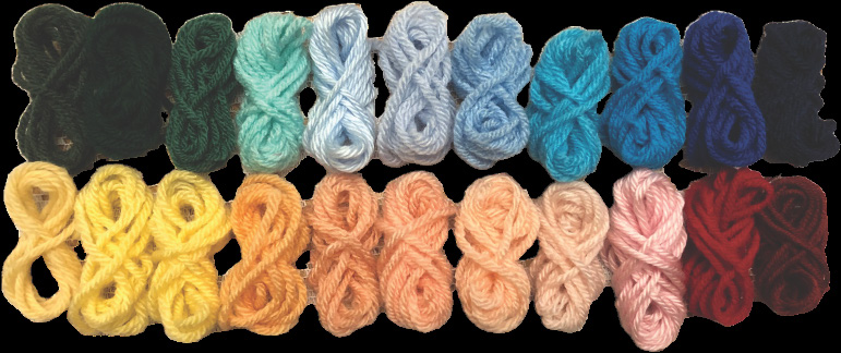 A collection of 18 small yarn bundles arranged in two horizontal rows. The top row contains dark and cool-toned colors, including black, dark green, teal, light blue, and shades of blue. The bottom row consists of warm-toned colors such as yellow, peach, light pink, red, and maroon. The yarn bundles are neatly looped and provide a visual representation of color variations.