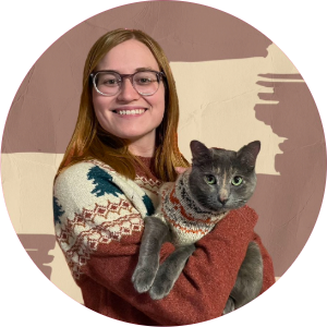 woman smiling holding grey cat