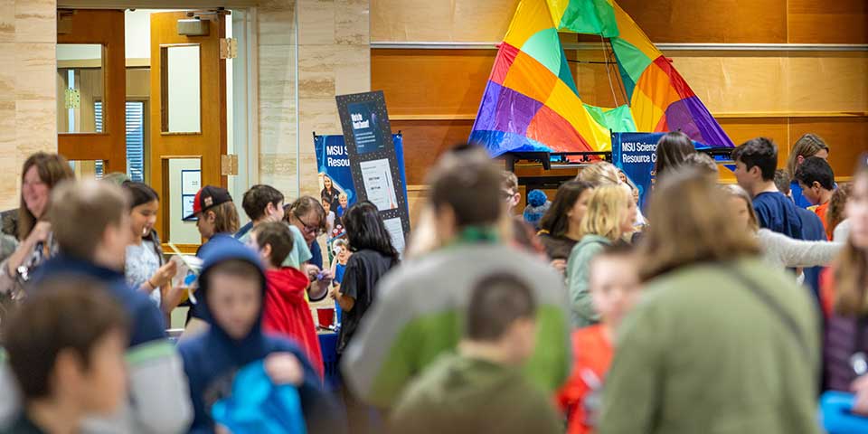 Crowd visiting displays at a science event